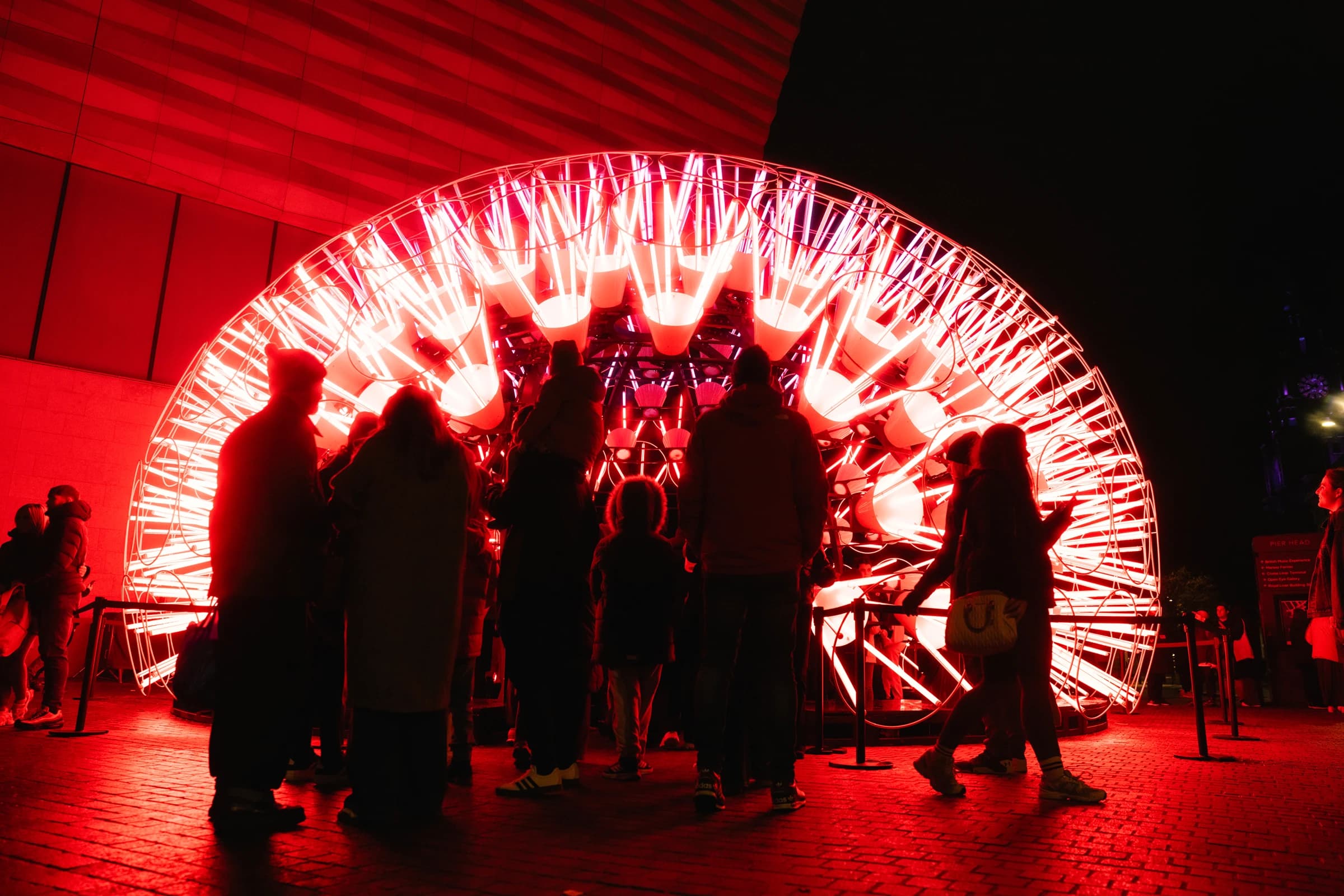 Group of people looking at red light display